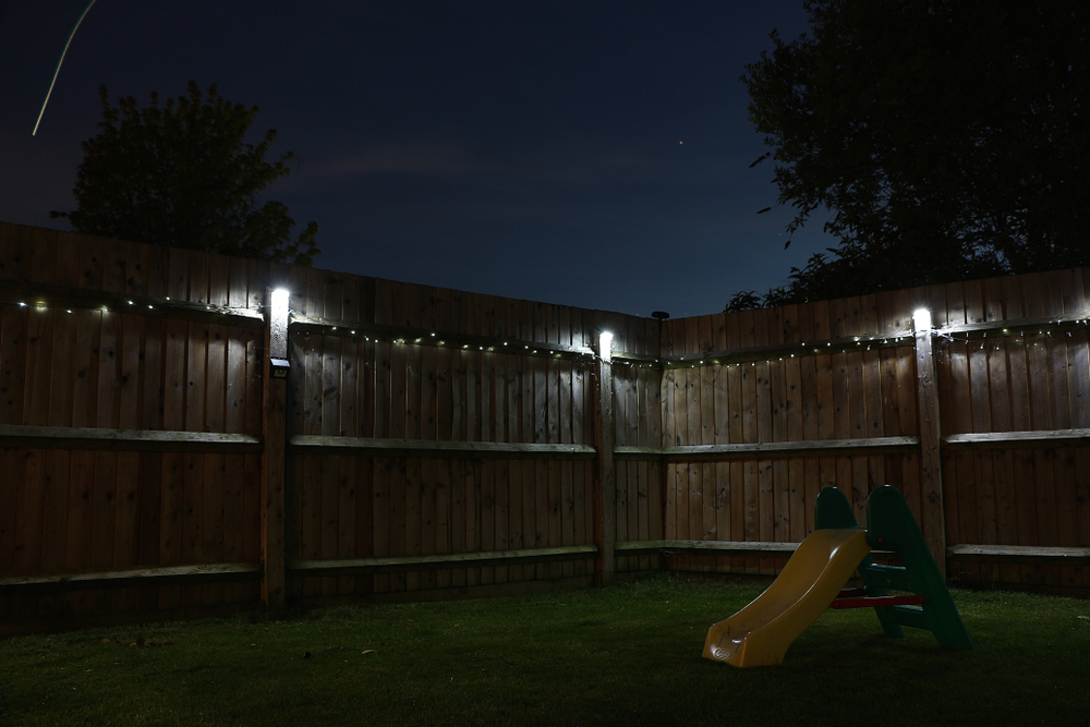 Bright backyard fence lighting for security.